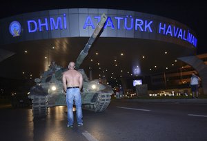 A man stands in front of a tank in the entrance to Istanbul's Ataturk airport, early Saturday, July 16, 2016. Members of Turkey's armed forces said they had taken control of the country, but Turkish officials said the coup attempt had failed.