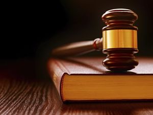 Wood and brass judges gavel on a law book