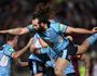 Blues' Aaron Woods crashes over the top of his teammates after they score the match-winning try in Origin III