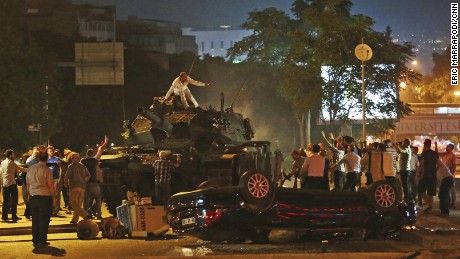 Tanks move into position as Turkish people attempt to stop them, in Ankara, Turkey, early Saturday, July 16, 2016. Turkey&#39;s armed forces said it &quot;fully seized control&quot; of the country Friday and its president responded by calling on Turks to take to the streets in a show of support for the government. A loud explosion was heard in the capital, Ankara, fighter jets buzzed overhead, gunfire erupted outside military headquarters and vehicles blocked two major bridges in Istanbul.