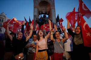 People chant slogans as they gather at a pro-government rally in central Istanbul's Taksim square, Saturday, July 16, 2016.