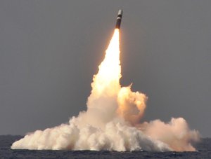 File - A trident II D-5 ballistic missile is launched from the Ohio-class ballistic missile submarine USS West Virginia during a missile test at the Atlantic Missile Range.