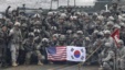 FILE - U.S. and South Korean army soldiers pose on a floating bridge on the Hantan river during a joint military exercise against a possible attack from North Korea, in Yeoncheon, South Korea, Dec. 10, 2015. 