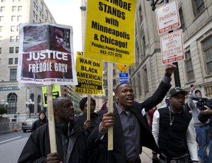 Demonstrators protest outside of the courthouse in response to a hung jury and mistrial for Officer William Porter, one of six Baltimore city police officers charged in connection to the death of Freddie Gray, Wednesday, Dec. 16, 2015, in Baltimore.