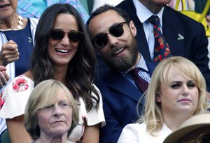 Pippa Middleton, left, James Middleton,  and actress Rebel Wilson,  right, sit in the Royal Box before the match between Novak Djokovic of Serbia and Jamie Ward of Britain, during day one of the Wimbledon Tennis Championships in London,  Monday, June 27, 2016. (AP Photo/Alastair Grant)