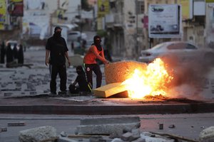 Bahraini anti-government protesters burn old furniture during clashes with riot police in Daih, Bahrain, Monday, March 14, 2016.