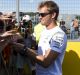 Staying put: Nico Rosberg signs autographs in Budapest on Thursday.