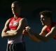 Sibling rivalry: Xavier Richards handballs at Swans training while brother Ted looks on.