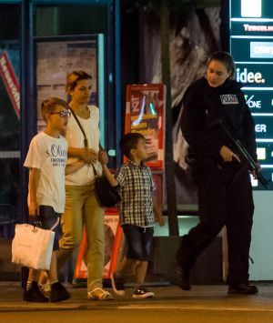 MUNICH, GERMANY - JULY 22:  Police officers escort people out of the Olympia Einkaufzentrum (OEZ) shopping mall on July ...