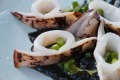 Grilled calamari with squid ink is on the menu.