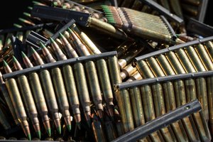 Clips of 5.56 mm ammunition lie in a bucket ready to be loaded into M16 magazines by competitors