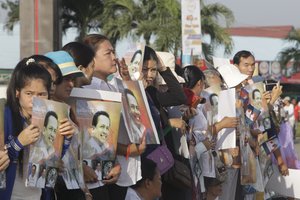 People watch the funeral procession of Cambodian leading government critic Kem Ley in Phnom Penh, Cambodia, Sunday, July 24, 2016