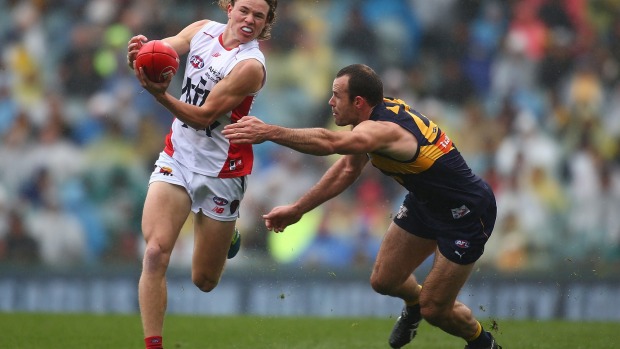 PERTH, AUSTRALIA - JULY 23: Jayden Hunt of the Demons handballs against Shannon Hurn of the Eagles during the round 18 ...