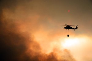 California Air National Guardsmen from the 129th Rescue Wing perform precision water bucket drops in support of the Rim Fire suppression operation at Tuolumne County near Yosemite, Calif., Aug. 26, 2013.  (Courtesy photo by Staff Sgt. Ed Drew)