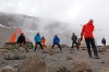 Cricketers practice on the ice-covered crater of the Kilimanjaro mountain, Tanzania.