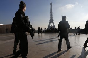 French police officers patrol near the Eiffel Tower, in Paris