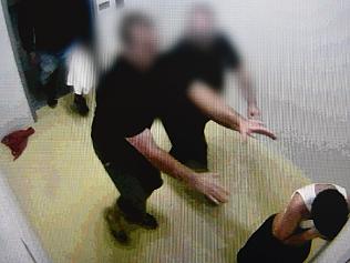 This frame grab from Australian Broadcasting Corporation's (ABC) Four Corners program broadcast in Australia on July 25, 2016 and released on July 26, 2016 shows a teenage boy (R) allegedly being pushed by prison guards at a youth detention centre in the Northern Territory city of Darwin. The Australian government ordered an inquiry on July 26 after graphic evidence emerged of prison guards assaulting teenage boys, with one shown hooded and shackled in scenes likened to Guantanamo Bay. / AFP PHOTO / Australian Broadcasting Corp’s Four Corners / Australian Broadcasting Corp’s Four Corners / -----EDITORS NOTE --- RESTRICTED TO EDITORIAL USE - MANDATORY CREDIT "AFP PHOTO / Australian Broadcasting Corp’s Four Corners" - NO MARKETING - NO ADVERTISING CAMPAIGNS - DISTRIBUTED AS A SERVICE TO CLIENTS - NO ARCHIVES EDITORS NOTE: Blurring of faces is from source /