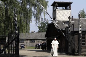 Pope Francis walks through the gate of the former Nazi German death camp of Auschwitz in Oswiecim, Poland, Friday, July 29, 2016