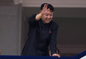 File - North Korean leader Kim Jong Un leans over a balcony and waves to Korean War veterans cheering below at the end of a mass military parade on Kim Il Sung Square in Pyongyang to mark the 60th anniversary of the Korean War armistice on July 27, 2013.