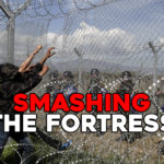 Protesting migrants try to bring down part of a border fence as Macedonian police stand guard during clashes at a makeshift camp for refugees and migrants at the Greek-Macedonian border near the village of Idomeni, Greece, April 10, 2016. REUTERS/Alexandros Avramidis