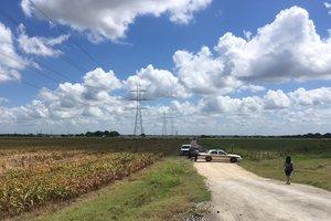 Police cars block access to the site where a hot air balloon crashed early Saturday, July 30, 2016, near Lockhart, Texas. At least 16 people were on board the balloon, which Federal Aviation Administration