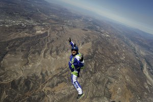 skydiver Luke Aikins smiles as he jumps from a helicopter during his training in Simi Valley, Calif. After months of training, this elite skydiver says he's ready to leave his chute in the plane when he bails out 25,000 feet above Simi Valley on Saturday. That's right, no parachute, no wingsuit and no fellow skydiver with an extra one to hand him in mid-air