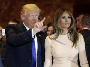 Republican presidential candidate Donald Trump, left, waves as he stands with his wife Melania Trump before speaking at a New York primary night campaign event, Tuesday, April 19, 2016, in New York.