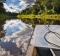 The bow of a touring skiff cruises along the calm waters of the Amazon.