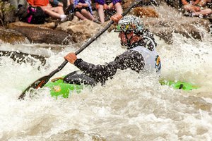 A man kayaking in a river.