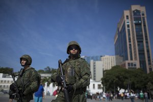 Soldiers patrol Maua square in Rio de Janeiro, Brazil, Saturday, July 9, 2016, as security is deployed to get to know the areas they'll be patrolling during the Olympics.