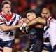 Sandwiched: The Roosters defence latches onto Panthers rookie Nathan Cleary.