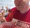 Mouthful: Tour guide Jason Kucherawy and some pulled pork poutine.