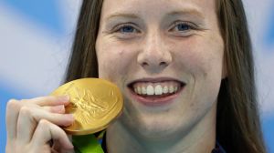 United States' Lilly King shows off her gold medal.