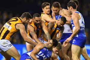 Players wrestle after a bump by the Roos' Jack Ziebell on Hawk Sam Mitchell in their round 13 clash. 