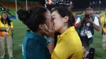 Volunteer Marjorie Enya (R) and rugby player Isadora Cerullo of Brazil kiss after the marriage proposal. 