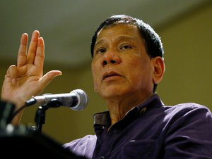 In this Nov.30, 2015 photo, Davao City Mayor Rodrigo Duterte gestures as he addresses supporters during his proclamation as the PDP-Laban Party's standard-bearer for the May 9, 2016 presidential elections in Manila, Philippines.