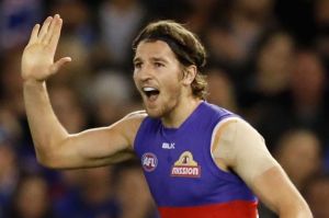 Undaunted: Jason Johannisen celebrates a goal with Marcus Bontempelli, who had a great game despite physical attention ...