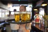 A barman carries a tray of draught Grolsch beer glasses, produced by SABMiller Plc, in a bar in Utrecht, Netherlands.