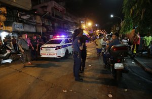 In this June 8, 2016 file photo, police conduct an overnight curfew for minors in Manila, Philippines. Even before he takes his oath of office on Thursday, Philippine President-elect Rodrigo Duterte's vow to kill drug criminals appear already being rolled out.