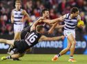 Jack Newnes and Dylan Roberton tackle Steven Motlop of the Cats. 