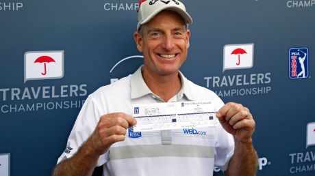 Jim Furyk of the United States poses with his scorecard after shooting a record 58 during the final round of the ...