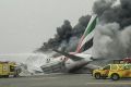 The smoking Emirates plane at Dubai airport.