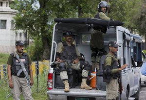 Pakistani security troops stand guard outside the Supreme Court as people gather to pray for victims of a bomb blast Monday in Quetta, in Islamabad, Pakistan, Tuesday, Aug. 9, 2016.