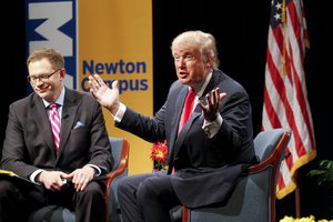 Republican presidential candidate Donald Trump speaks with host Dave Price during the WHO-HD Iowa Forums at the Des Moines Area Community College Newton Campus, Thursday, Nov. 19, 2015, in Newton, Iowa.