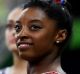 Simone Biles of the United States checks the scoreboard.