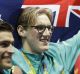 Mack Horton, centre, celebrates after beating Sun Yang, right. in the the men's 400m freestyle.