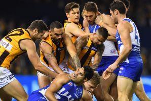 MELBOURNE, AUSTRALIA - JUNE 17:  Players wrestle after a bump by Jack Ziebell of the Kangaroos on Sam Mitchell of the ...