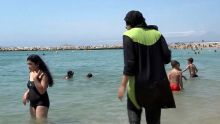 Nissrine Samali, 20, gets into the sea wearing traditional Islamic dress, in Marseille, southern France.