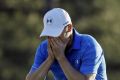 Tough day: Jordan Spieth on the 18th green at Augusta.