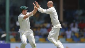 Mistimed sweep: Nathan Lyon celebrates the wicket of Angelo Mathews off an ill-judged shot with Mitchell Marsh.